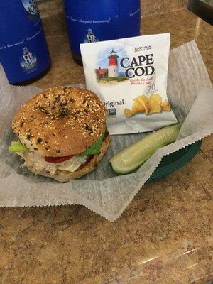 Tuna salad on an everything bagel, served with a pickle and chips!