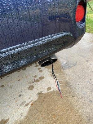 The shop left the wires unprotected and fell from my rear bumper.  They should have taped and secure them.