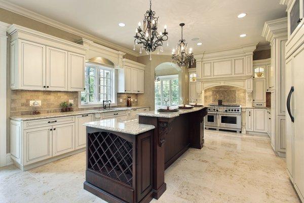 Elegant Kitchen With White Cabinets And Travertine Countertops