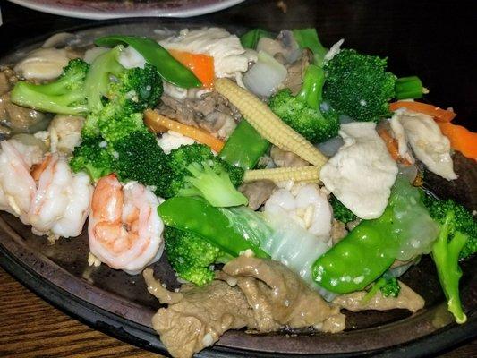 Triple Delight (chicken, shrimp, beef) on a sizzling plate.