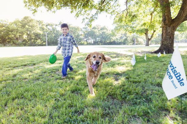 A boy and his dog playing in the yard.