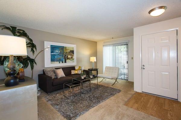 Spacious living room leading into private patio!