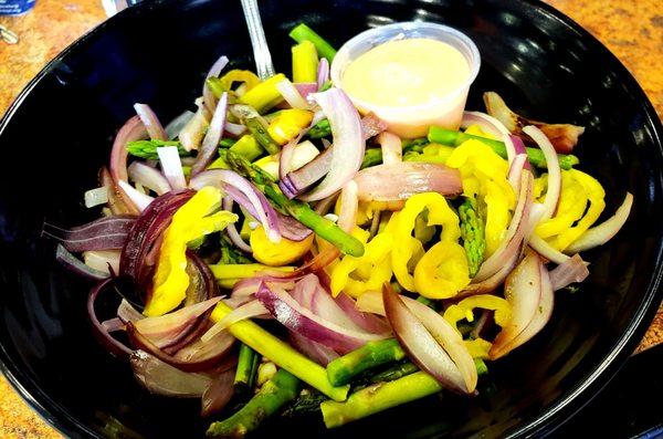 Bowl with cauliflower rice, chicken, banana peppers, red onion, and asparagus