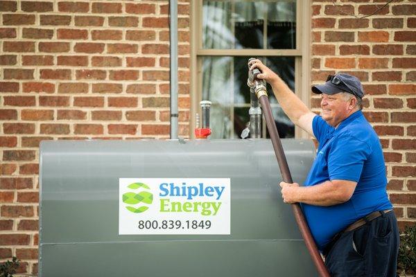 Heating Oil Delivery Driver Filling A Customer's Tank