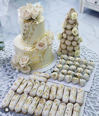 Eclairs, chocolate covered strawberries, two tier cake & a macaron tower