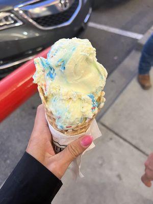 Small Birthday cake ice cream in a waffle cone