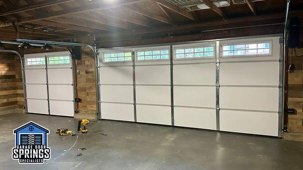 Freshly installed double and single garage doors with sleek side-mounted openers, ensuring smooth operation of the garage doors.