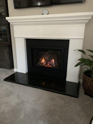 Finished fireplace with metal surround.