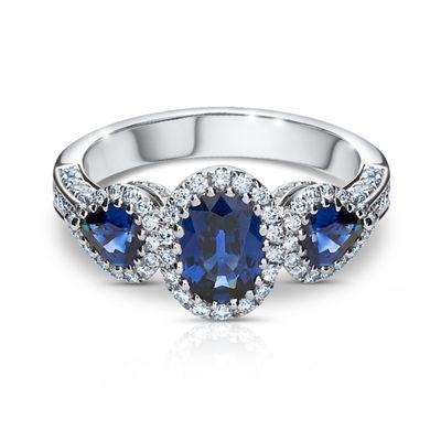 Blue Sapphire, incredible blue. Diamonds around. Trilogy setting.