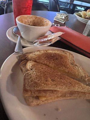 Cup of chili (many bites out of it!) and a grilled cheese.