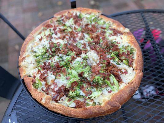 Red Potato Pizza: a plain crust pizza with sour cream, sliced red potatoes, sharp cheddar cheese, chives, bacon, and broccoli