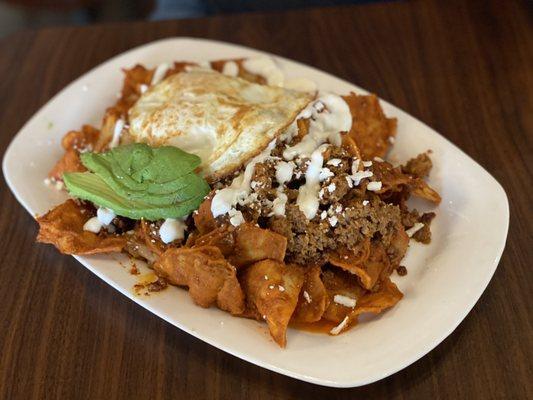 Mount Chilaquilas topped with fried egg and chorizo