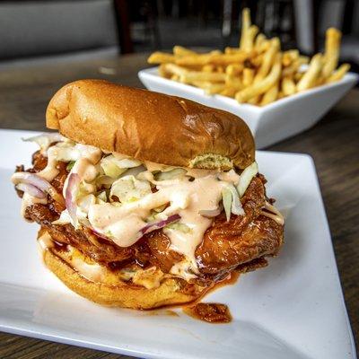 GHOST CHICKEN SANDWICH: crispy fried chicken sandwich with our house-made ghost pepper sauce with spicy mayo, pickles, and ghost slaw.