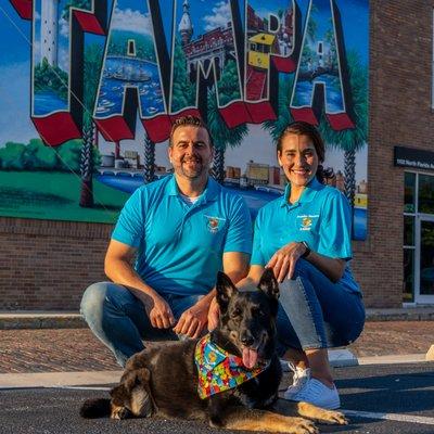 Owners in front of the historic Tampa mural.