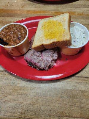 Brisket baked beans potato salad and garlic toast .