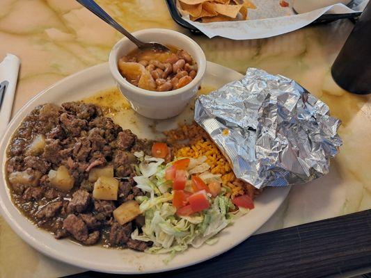 Green chili, charro beans, tomato and shredded lettuce with corn tortillas in foil.