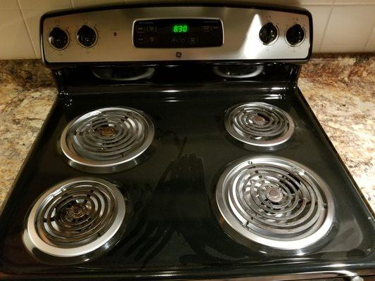 Dusty stovetop. No one's been in this apartment for a long while