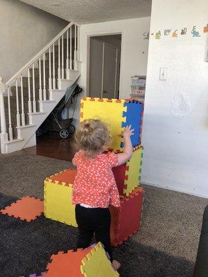 Madeline building her tower.