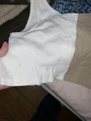 dirt smudges on the white part of a shirt after "washing" & drying