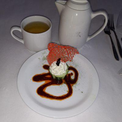 Cucumber cup with feta mouse cream, tomato lace, parsley powder, and tomato swirl