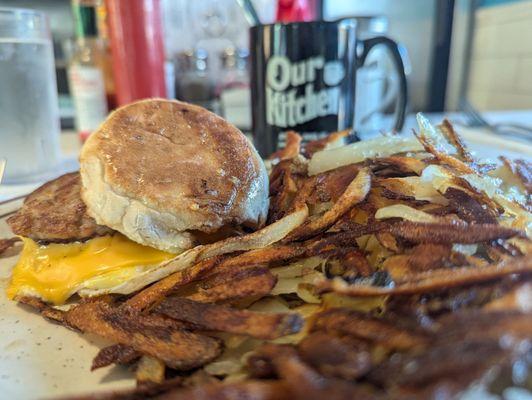 Egg, cheese, and sausage sandwich (English muffin) with hashbrowns (of course.)