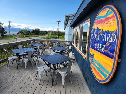 Summer deck, with views of the kachemak bay. In an active boatyard