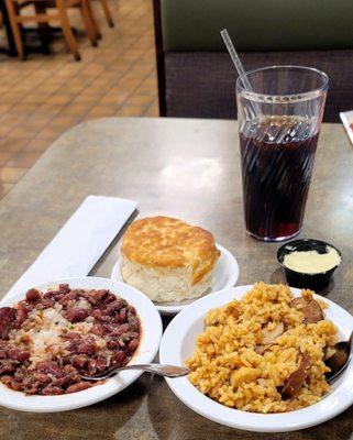 02/17/23 Bowls of red beans rice with Cajun sausage Jambalaya w/ chicken and cajun pork sausage And the biscuit. filling this way Diet Pepsi