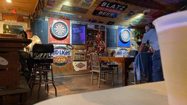 Two dartboards, a cozy bar and a few tables.