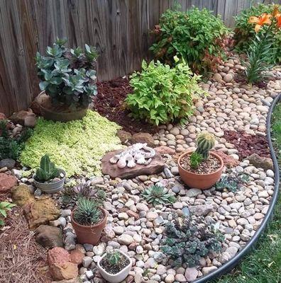 Beautiful rock flower bed with planters