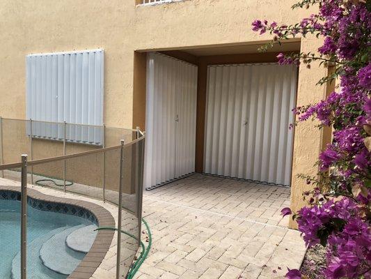 White Accordion Shutters on a beautiful new home.