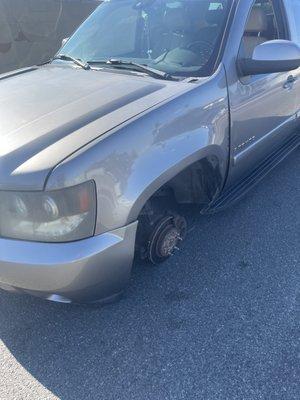 Truck on the ground after wheel fell off