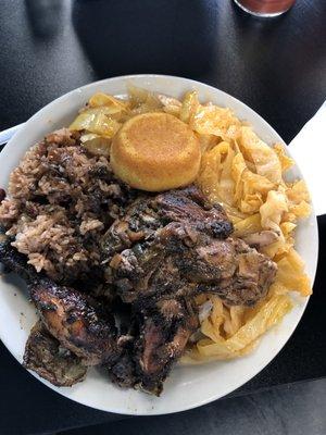 Jerk chicken with rice and peas (beans), double cabbage, and corn bread