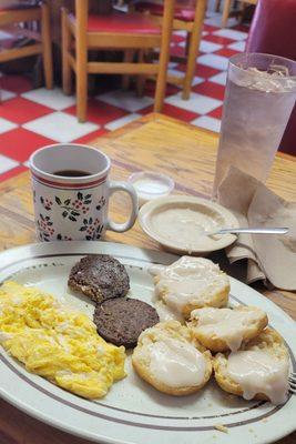 My breakfast two eggs soft scrambled two sausage patties no toast biscuits and gravy little extra gravy cawfee