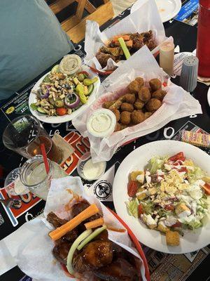 Two sets of 10 wings, both with mixed sauces. Fried mushrooms and pickle spears. Homemade ranch dressing and two half salads.