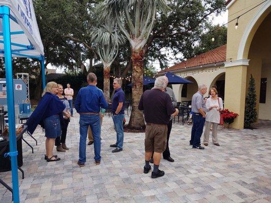 Folks finding community on the Cypress Meadows patio after Sunday service