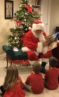 Santa sits in a cozy chair, reading holiday tales to eager children , while parents and friends gather around, sharing laughter and joy.