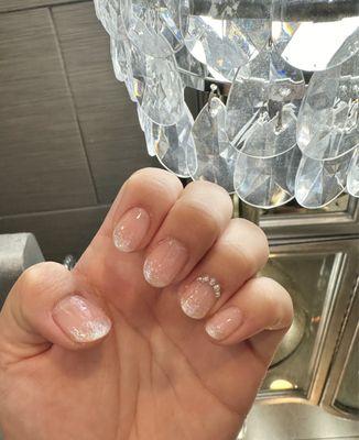 Gel manicure with sparkly ombre tips and rhinestones