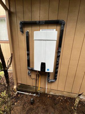 outdoor on demand water heater install. re-engineered hot and cold from inside home to outside home.