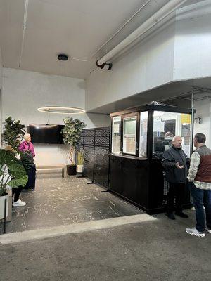 Well lit waiting area with benches.