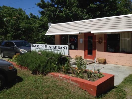 Front of the place, with sign offering Home Cooking, Sandwiches, and Catering.