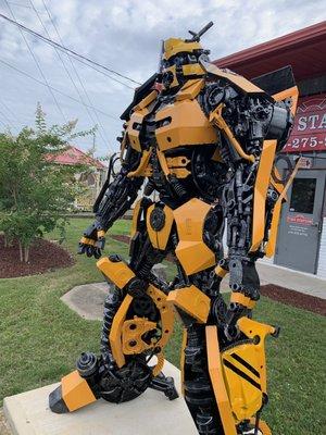 A cool statue of the Bumblebee character from the Transformers series.