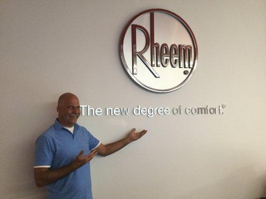 One of the owners of GW poses at the Rheem Corporate Training center after a several day training course on their products.