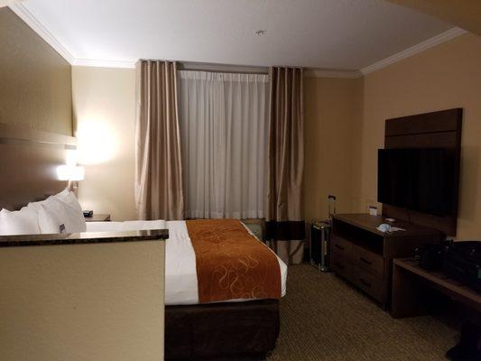 Bedroom area with large flatscreen TV.  The large luggage shelf is a nice touch; looking for your stuff in your bags is much easier.