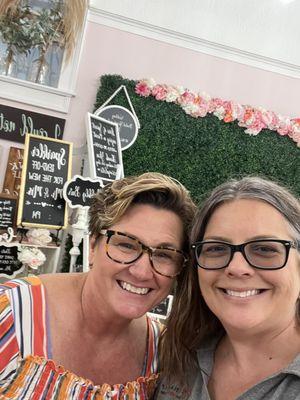 Me with an owner in front of the wedding/party backdrop.