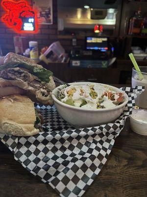 Mushroom Swiss burger with side salad and White Russian.