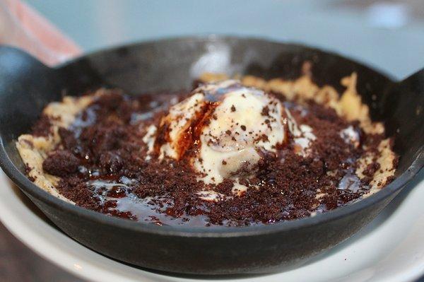 The Skillet Cookie is made with a salted chocolate chip cookie, your choice of ice cream (we chose cookie dough), & chocolate sauce