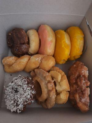 Different types of donuts (cake donut, twist donut, apple fritter)