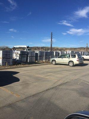 Lots of lumber and materials next to parking lot