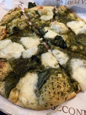 Pesto, fresh mozzarella, and basil pizza.