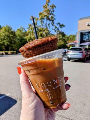 Iced pumpkin spice latte with oat milk and an apple cider donut